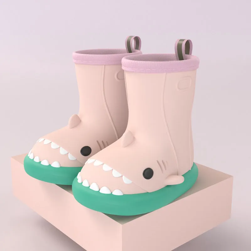 Shark and dinosaur design children's rain boots in green, available in multiple colours and sizes.