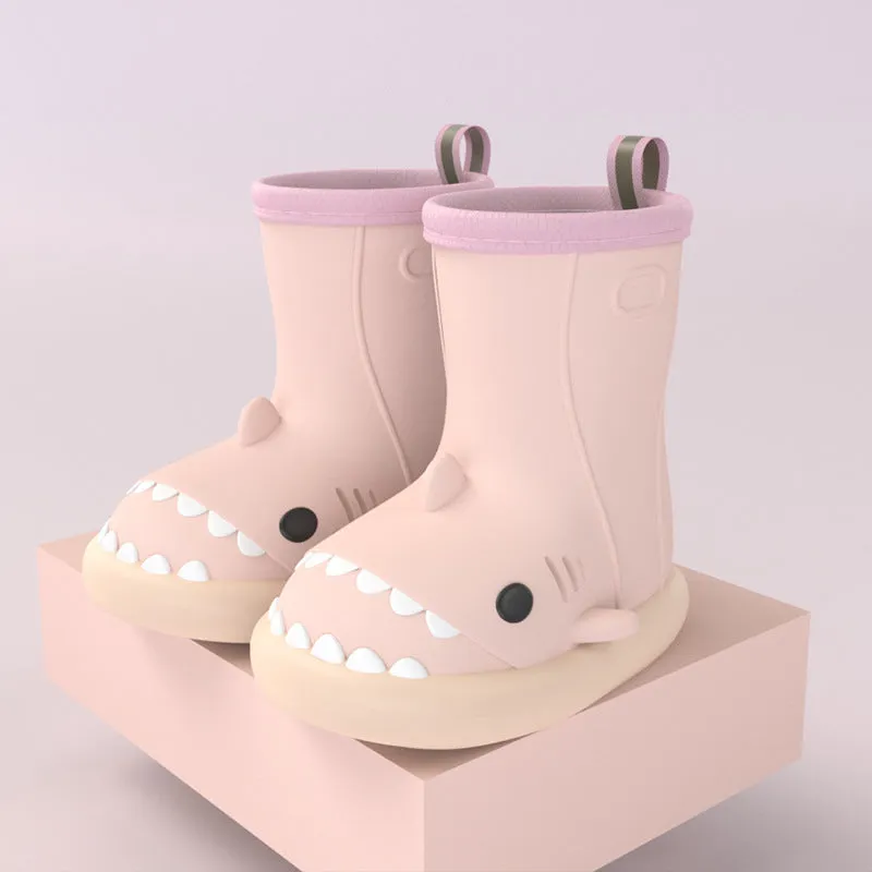 Shark and dinosaur design children's rain boots in green, available in multiple colours and sizes.
