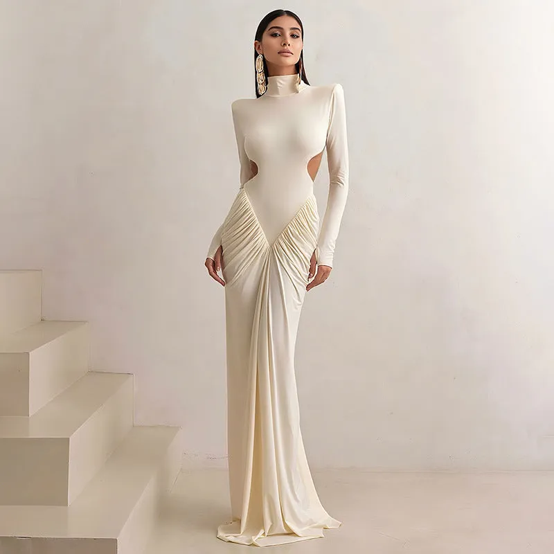 Women's slim fit long sleeve dress with high collar and pleated backless detail in apricot colour.