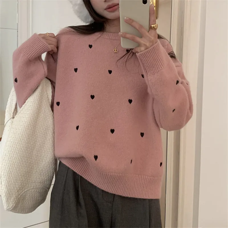 Women's loose cream embroidered acrylic pullover sweater with long sleeves, shown on a hanger.