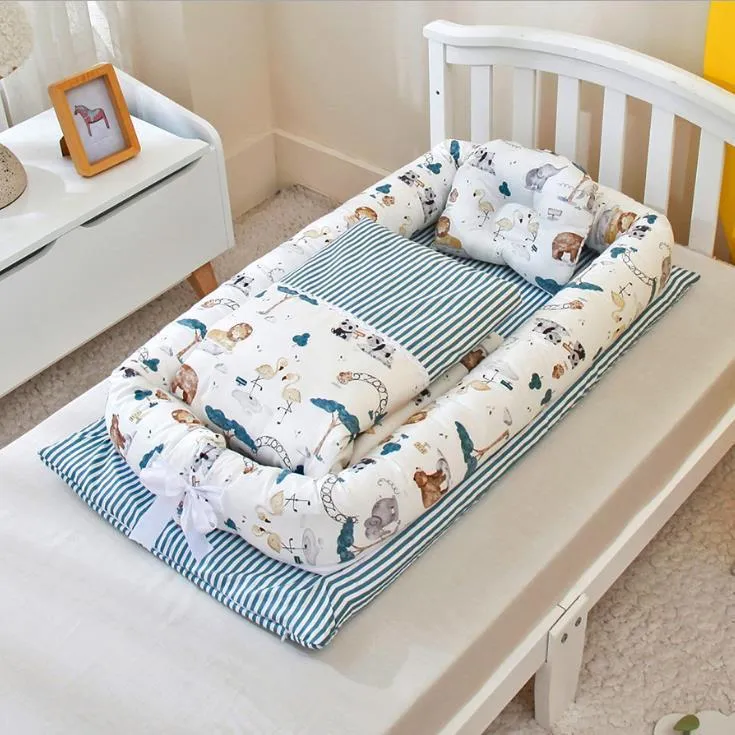 Portable foldable newborn crib with bionic mattress, cotton cover, and quilt in feather white style