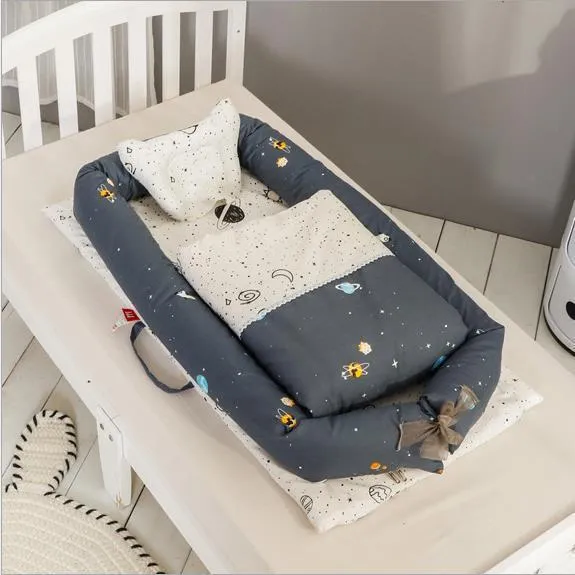 Portable foldable newborn crib with bionic mattress, cotton cover, and quilt in feather white style