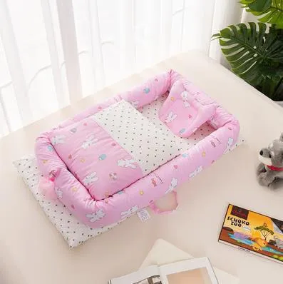 Portable foldable newborn crib with bionic mattress, cotton cover, and quilt in feather white style