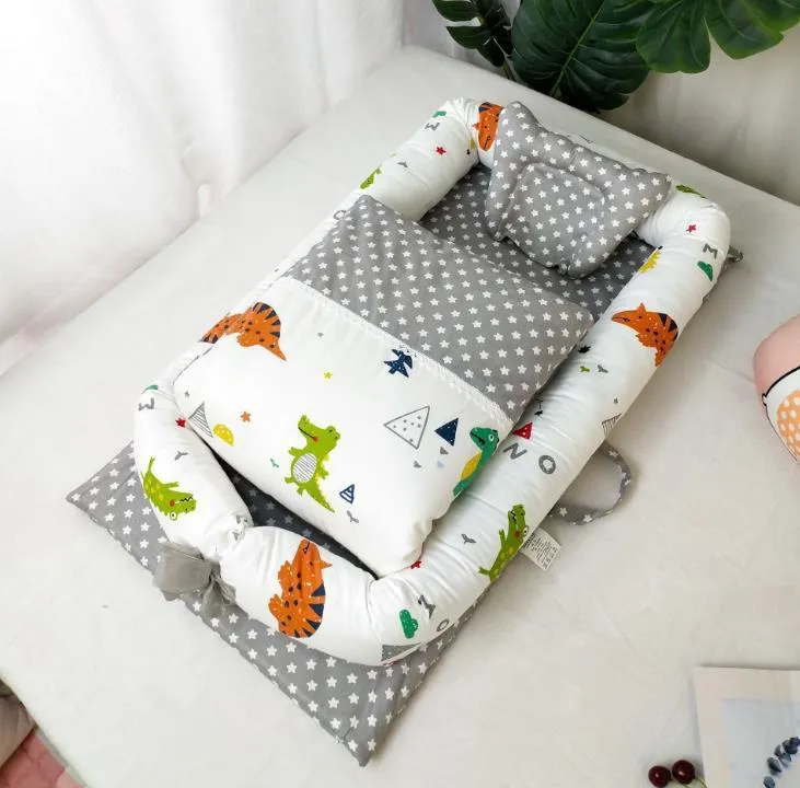 Portable foldable newborn crib with bionic mattress, cotton cover, and quilt in feather white style