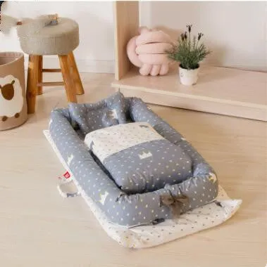 Portable foldable newborn crib with bionic mattress, cotton cover, and quilt in feather white style