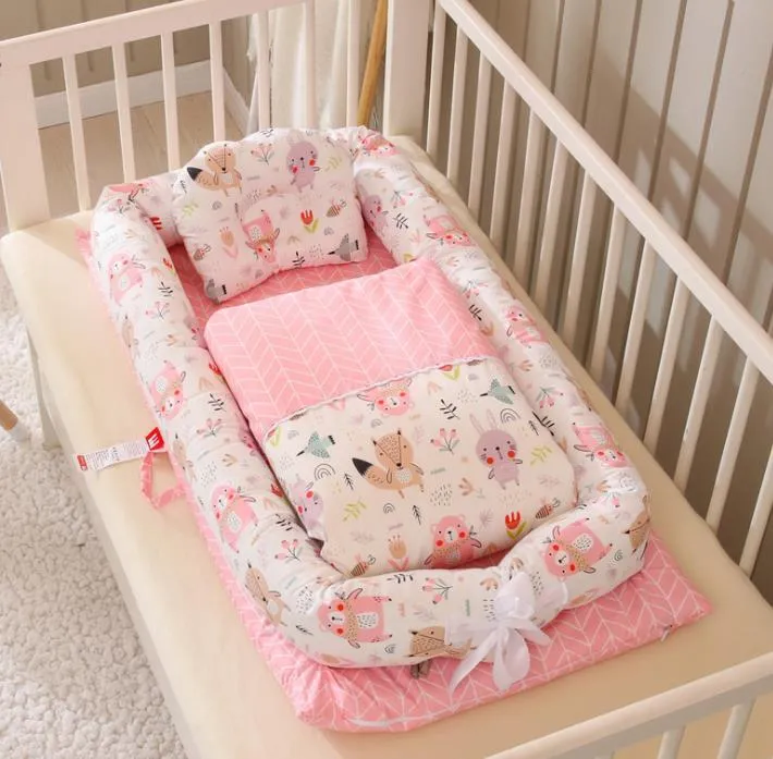 Portable foldable newborn crib with bionic mattress, cotton cover, and quilt in feather white style
