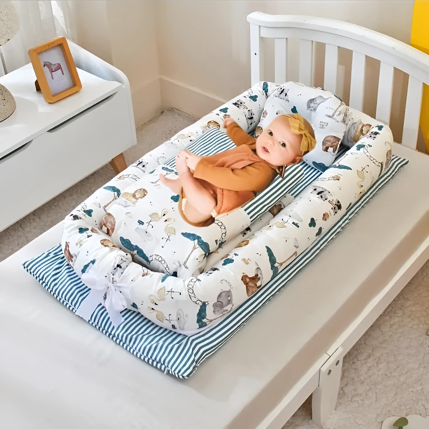 Portable foldable newborn crib with bionic mattress, cotton cover, and quilt in feather white style