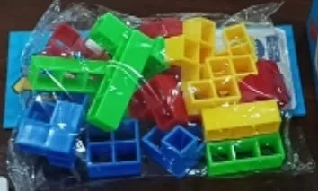 Balance stacking board game with 16 plastic coloured building blocks, base and chassis on a flat surface