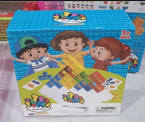 Balance stacking board game with 16 plastic coloured building blocks, base and chassis on a flat surface