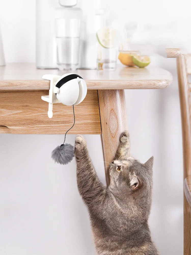 Electric automatic lifting cat toy with rabbit hair teaser and black ABS body on a light floor
