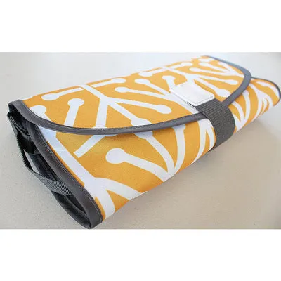 Portable baby diaper changing mat in yellow geometric pattern, 70x50cm, with toy ring and wrist strap unfolded on floor