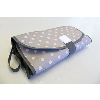 Portable baby diaper changing mat in yellow geometric pattern, 70x50cm, with toy ring and wrist strap unfolded on floor