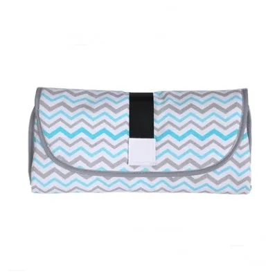 Portable baby diaper changing mat in yellow geometric pattern, 70x50cm, with toy ring and wrist strap unfolded on floor