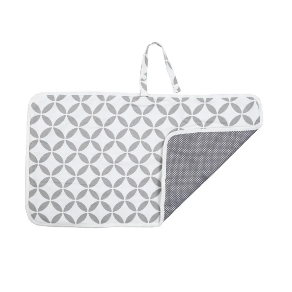 Portable baby diaper changing mat in yellow geometric pattern, 70x50cm, with toy ring and wrist strap unfolded on floor