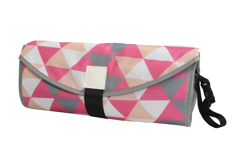 Portable baby diaper changing mat in yellow geometric pattern, 70x50cm, with toy ring and wrist strap unfolded on floor