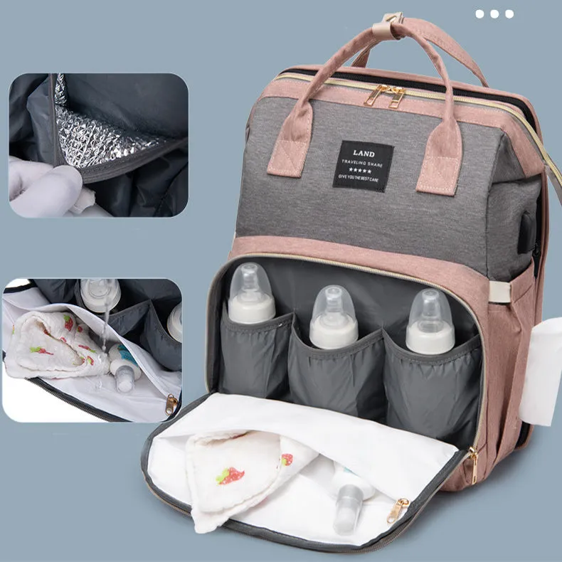 Large capacity insulated baby crib backpack in pink grey with double shoulder straps and outer pocket on white background