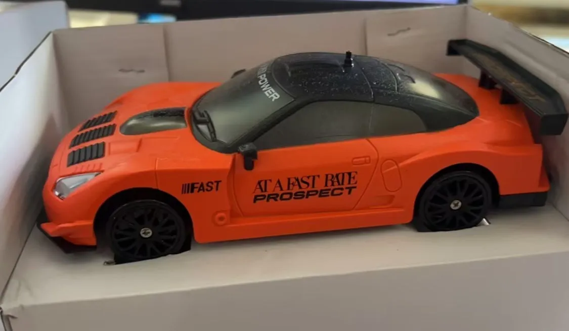 2.4G RC drift car 4WD 1:24 scale remote control toy GTR model in classic style on road with traffic cones