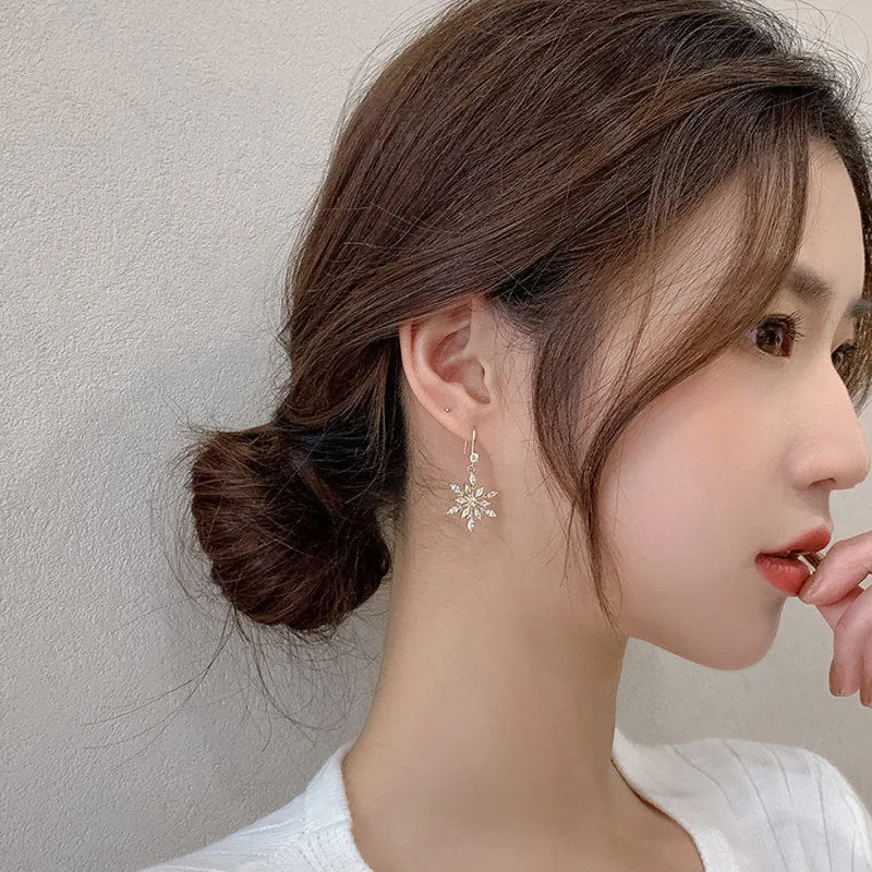 Gold snowflake earrings with zircon stones on alloy base, geometric design for women