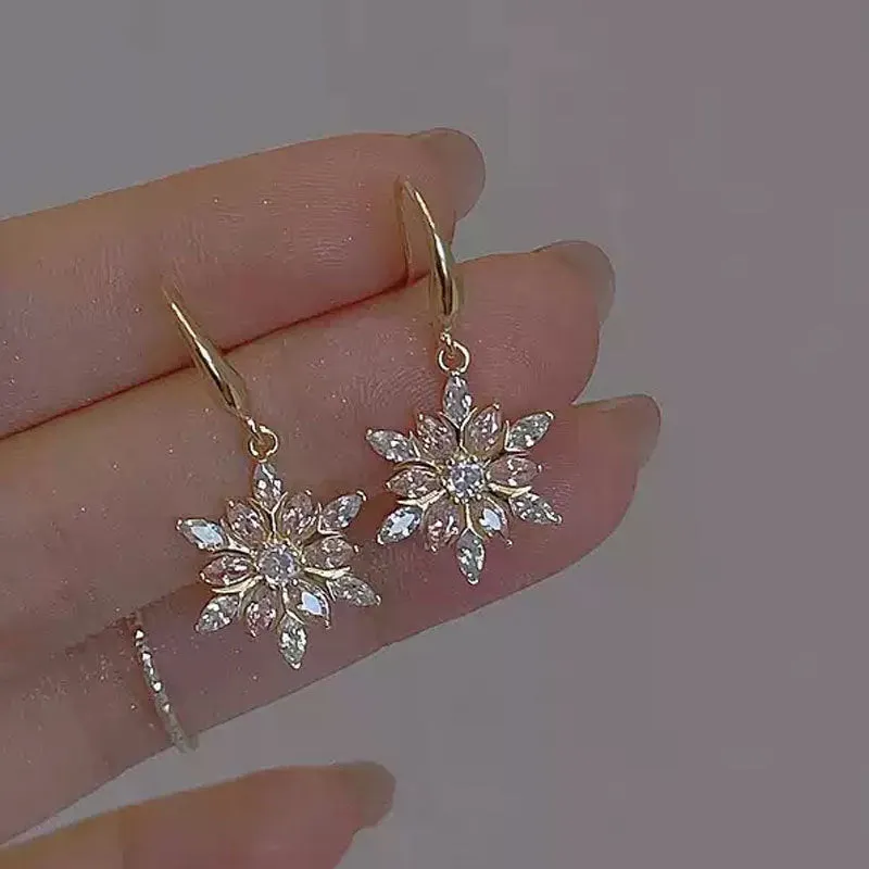 Gold snowflake earrings with zircon stones on alloy base, geometric design for women