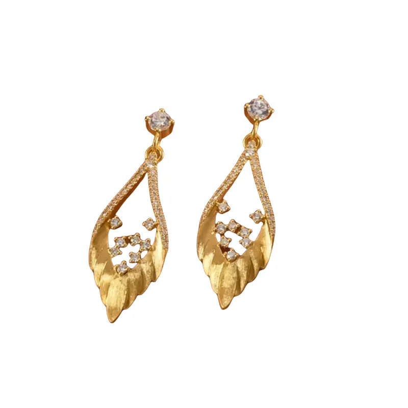 925 sterling silver brushed spot drill feather stud earrings in white gold colour on ear