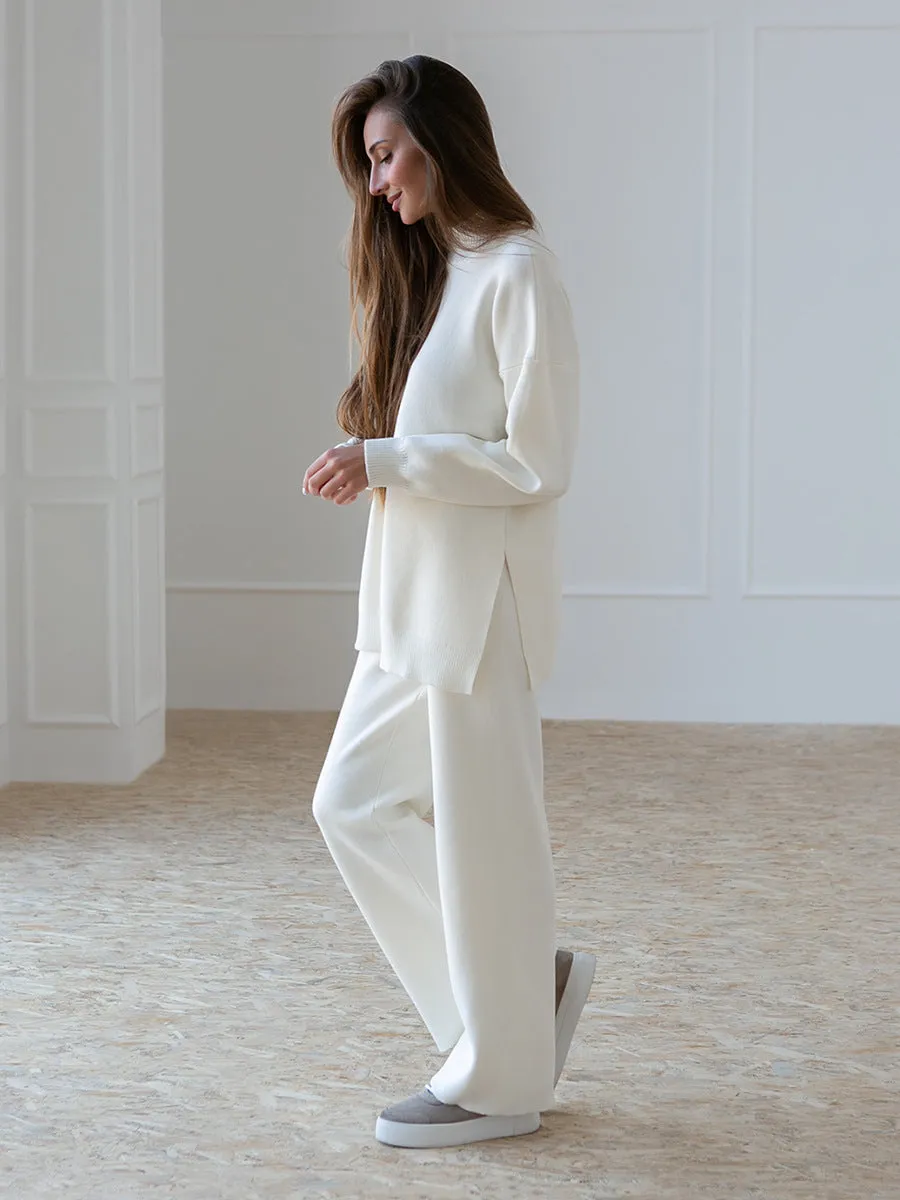 Women's turtleneck knit sweater suit set in solid colour with long sleeves and matching trousers on display