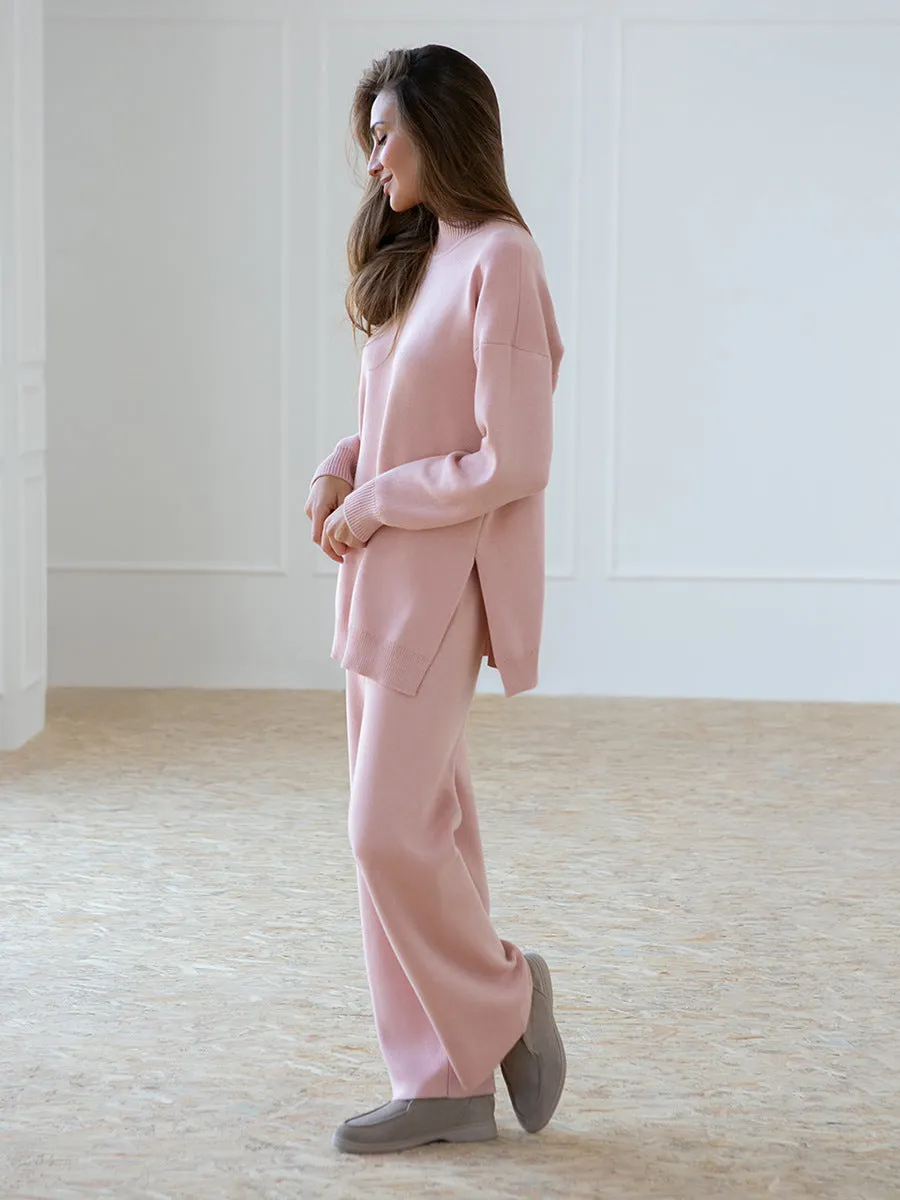 Women's turtleneck knit sweater suit set in solid colour with long sleeves and matching trousers on display