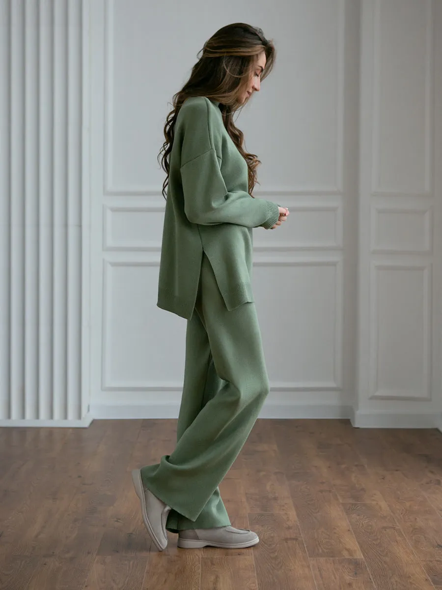 Women's turtleneck knit sweater suit set in solid colour with long sleeves and matching trousers on display