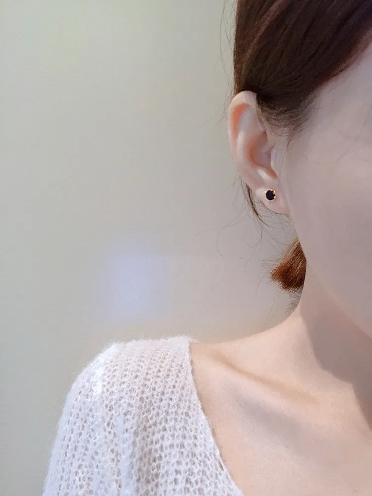 Black round mini ear studs in sterling silver plating with inlaid zircon on white background