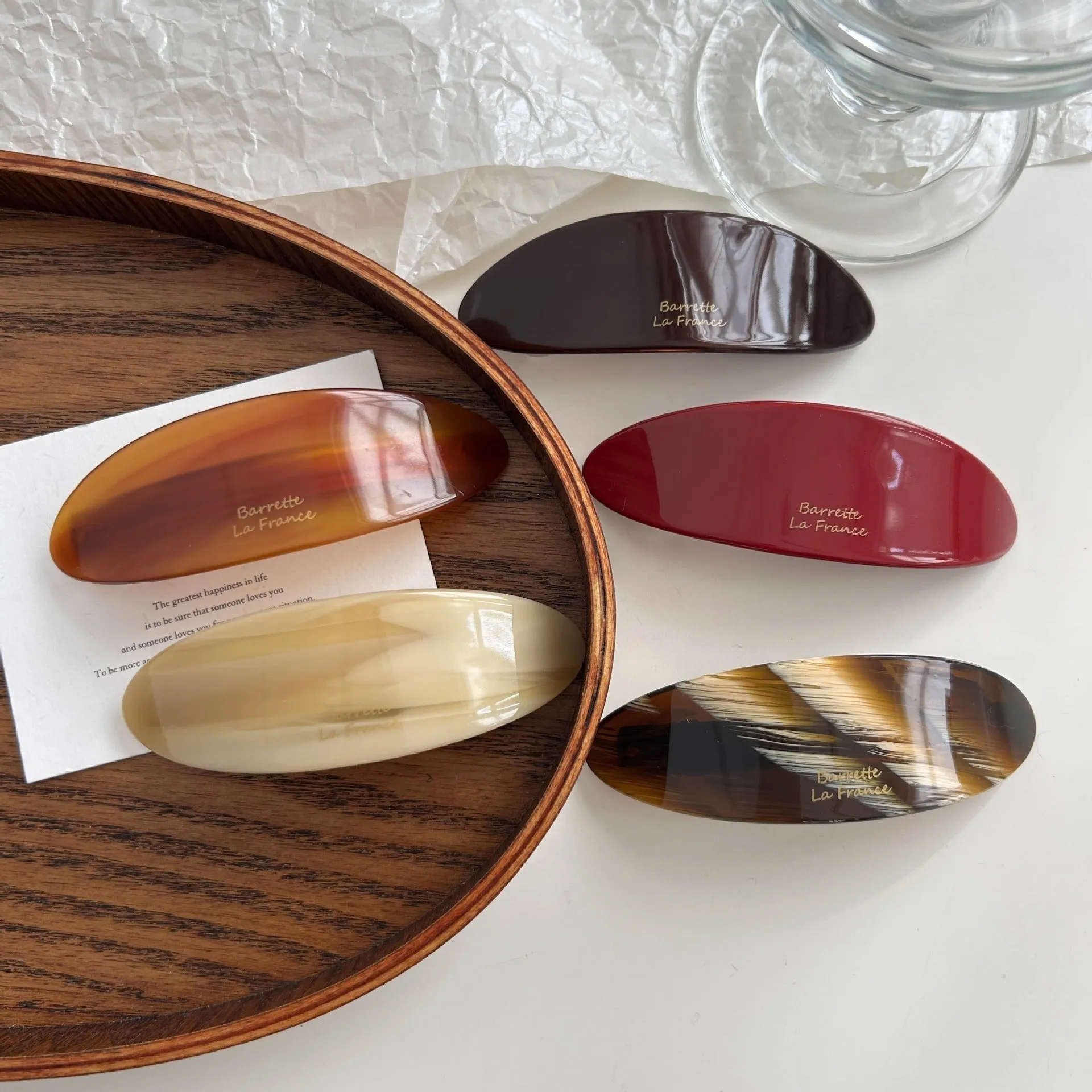 Mingshangjia acetic acid oval low ponytail hairpin in wine red colour on a plain background