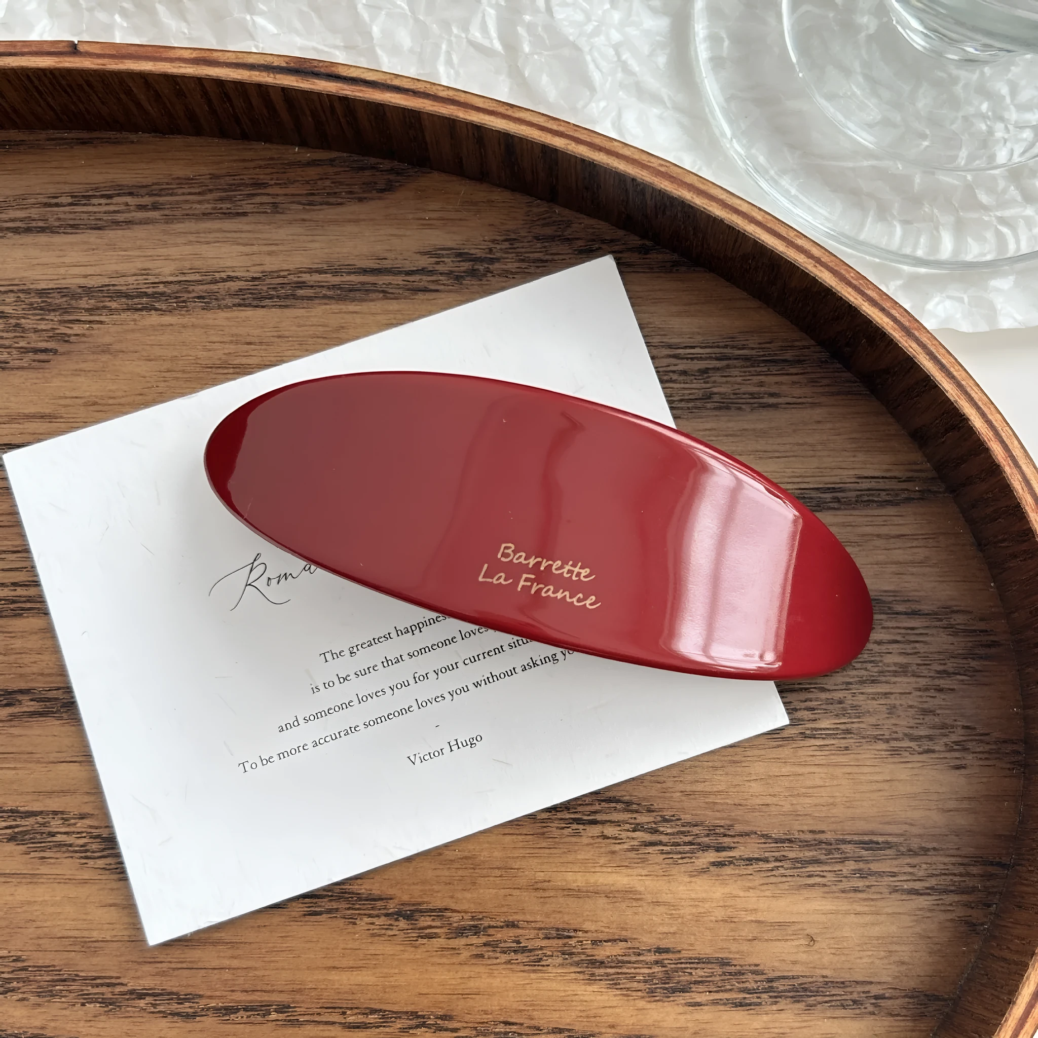 Mingshangjia acetic acid oval low ponytail hairpin in wine red colour on a plain background