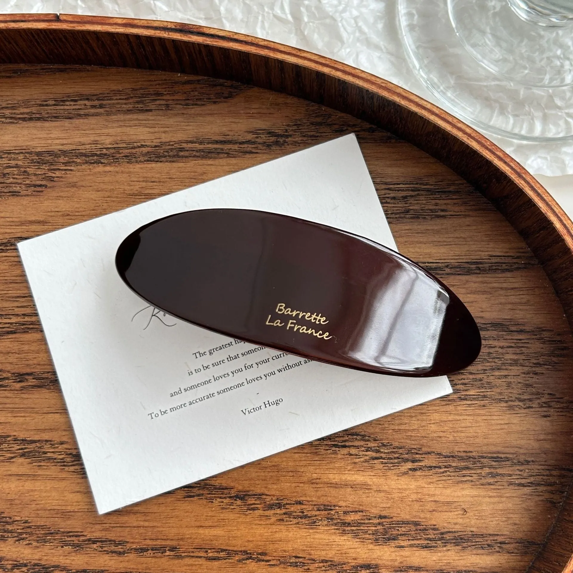 Mingshangjia acetic acid oval low ponytail hairpin in wine red colour on a plain background