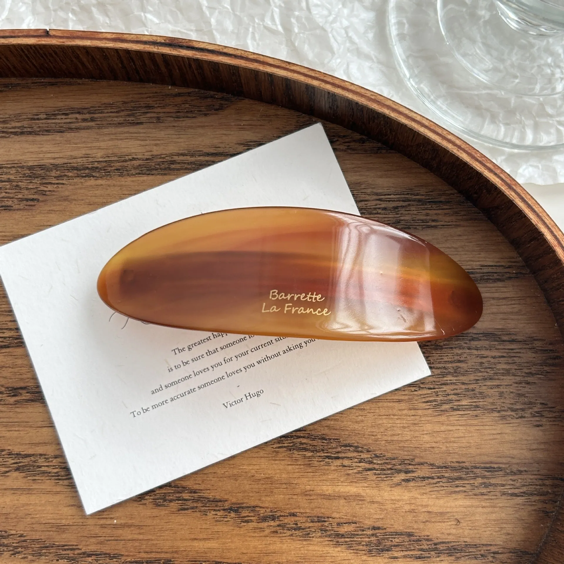 Mingshangjia acetic acid oval low ponytail hairpin in wine red colour on a plain background