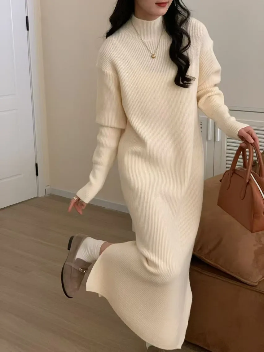 Woman wearing a milky white half turtleneck long sleeve knitted midi dress with a high waist.