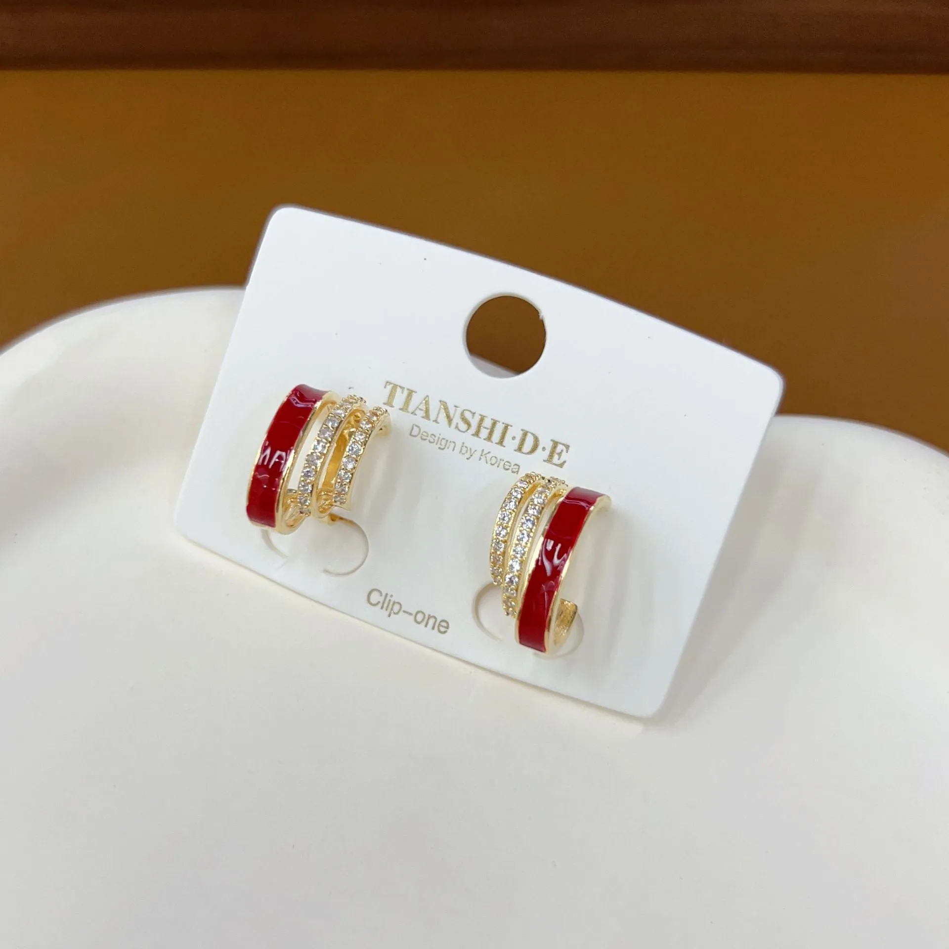 No piercing ear clip red full diamond painting oil stud earrings in geometric shape on woman's earlobe