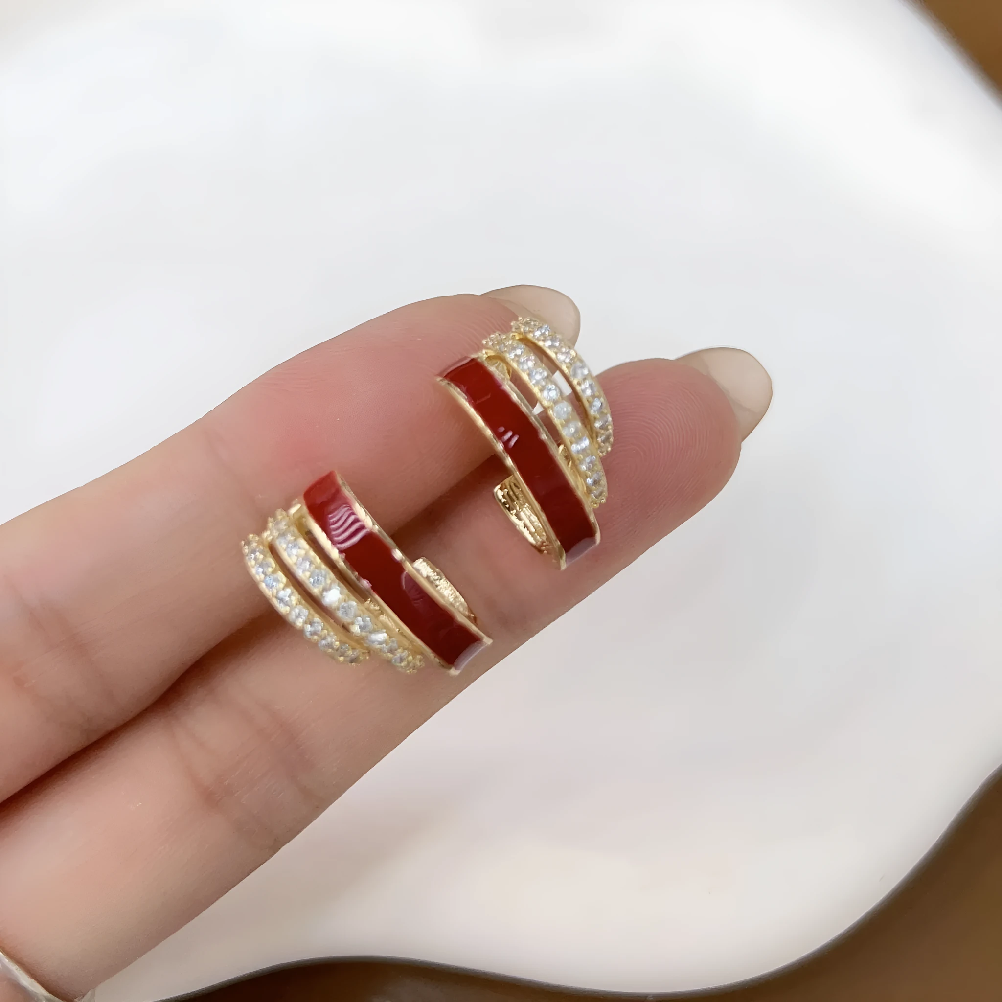 No piercing ear clip red full diamond painting oil stud earrings in geometric shape on woman's earlobe