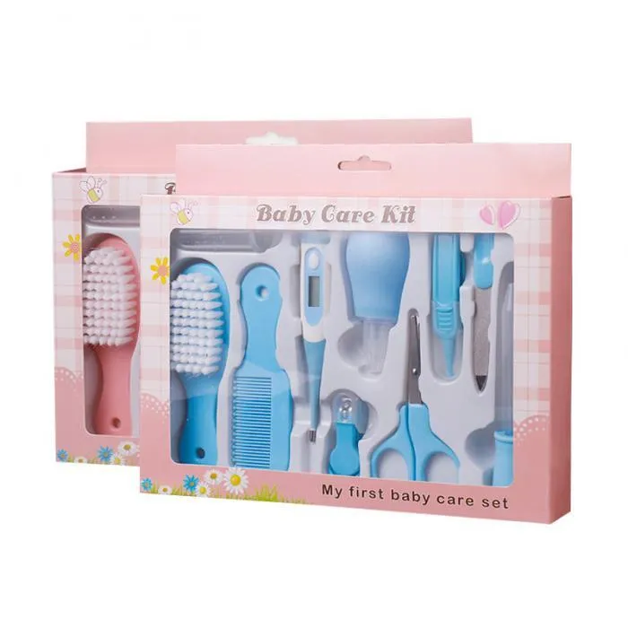Portable baby health suit 9-piece grooming set in pink with scissors, clippers, comb and thermometer on white background