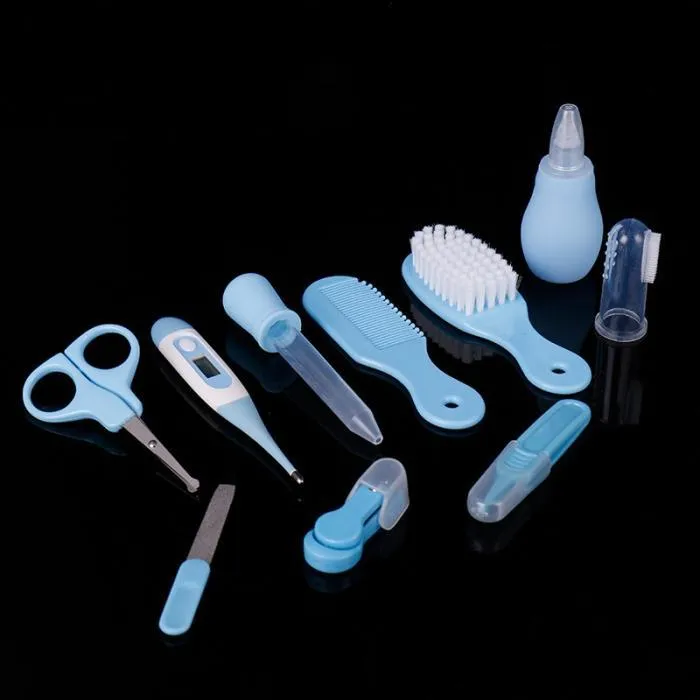 Portable baby health suit 9-piece grooming set in pink with scissors, clippers, comb and thermometer on white background