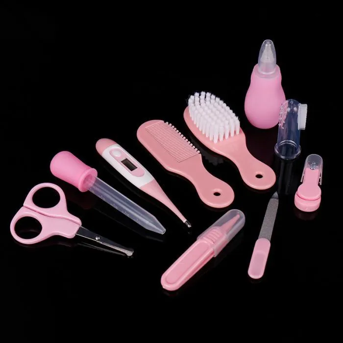 Portable baby health suit 9-piece grooming set in pink with scissors, clippers, comb and thermometer on white background