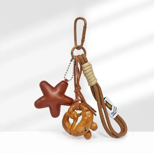 Handmade soda bread handbag pendant with baking varnish treatment showing five creative designs