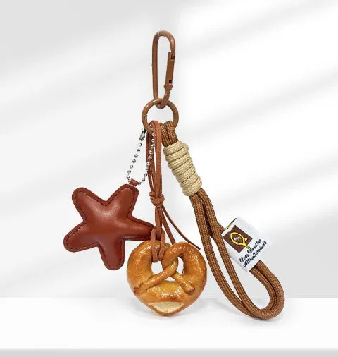 Handmade soda bread handbag pendant with baking varnish treatment showing five creative designs
