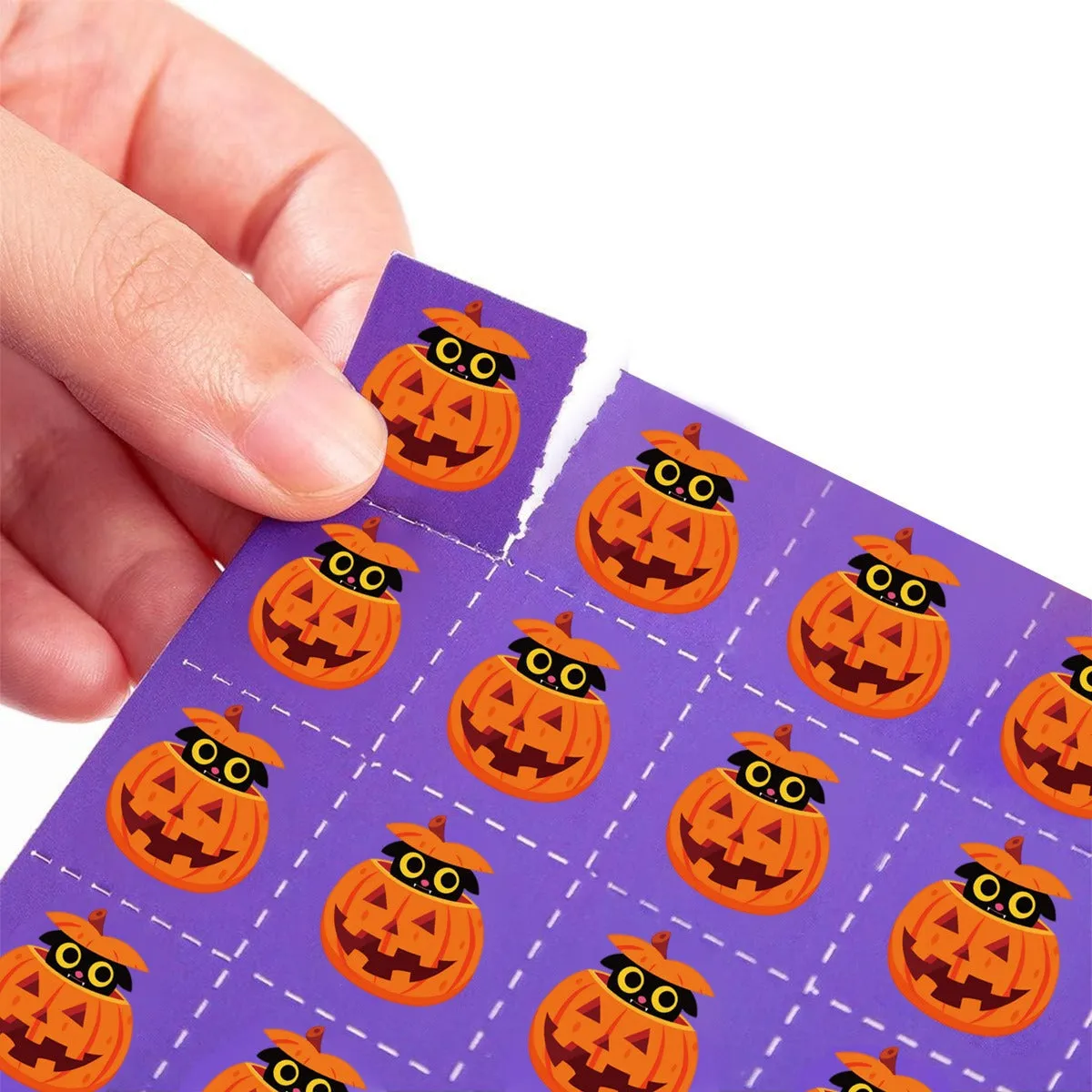 Halloween pumpkin bingo game cards on a table, paper set measuring 13x18 cm