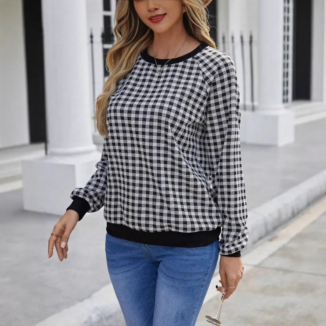 Black and white plaid print long sleeve pullover sweater for men on a neutral background.