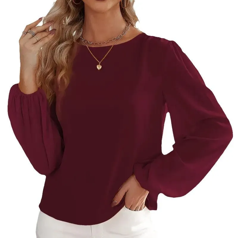 Wine red women's solid colour round neck long sleeve polyester top with button front, shown on a model.