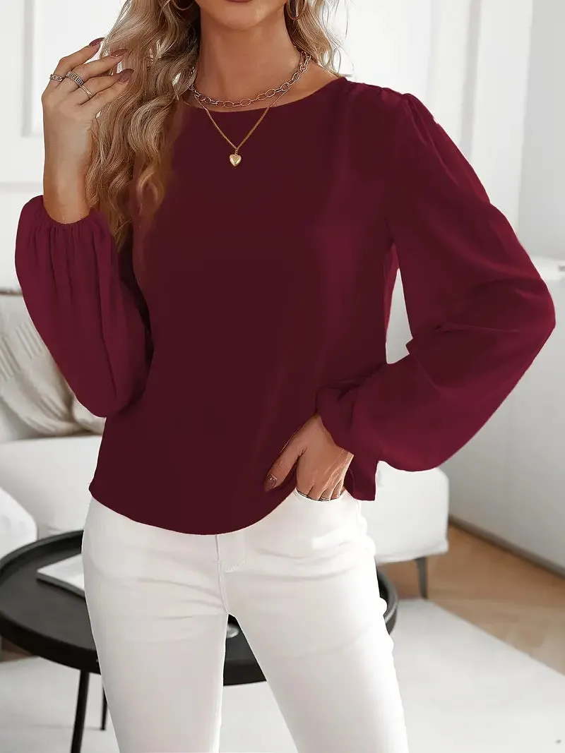Wine red women's solid colour round neck long sleeve polyester top with button front, shown on a model.