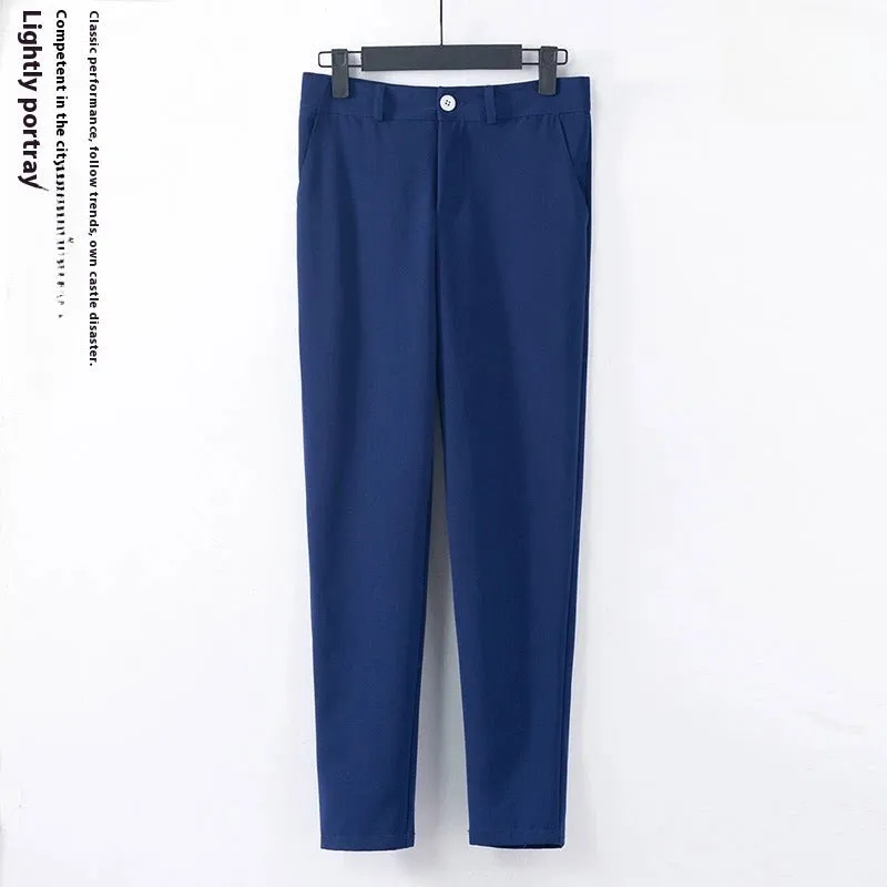 Blue polyester formal suit set with long sleeve jacket and cropped pants on a model