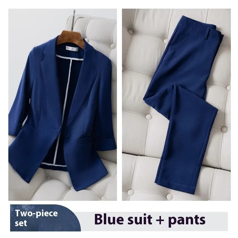 Blue polyester formal suit set with long sleeve jacket and cropped pants on a model