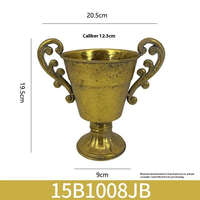 Metal decorative vase with black and gold finish, modern simplicity design on a tabletop