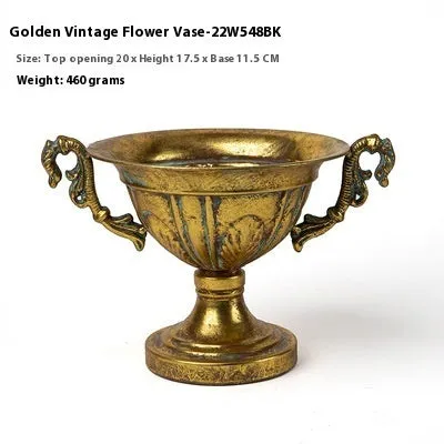 Metal decorative vase with black and gold finish, modern simplicity design on a tabletop