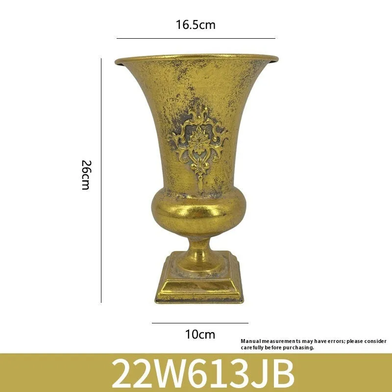 Metal decorative vase with black and gold finish, modern simplicity design on a tabletop
