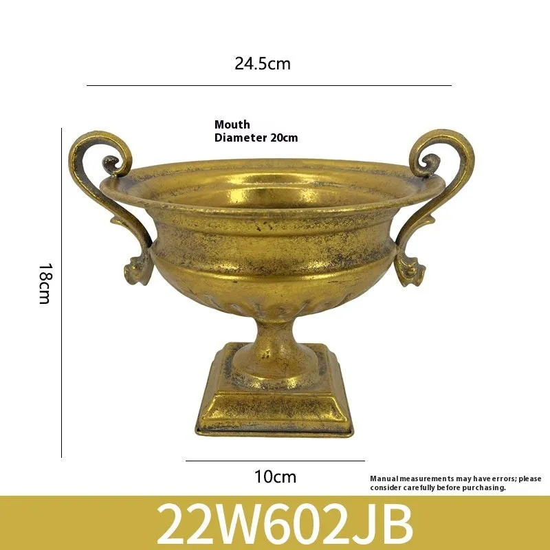 Metal decorative vase with black and gold finish, modern simplicity design on a tabletop